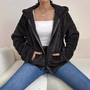 Close-up of black fuzzy fleece hoodie jacket featuring a front zipper and side pockets