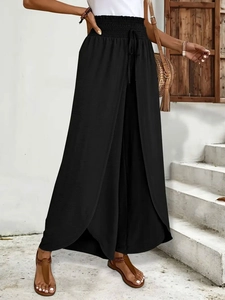Elegant high waisted black split-leg wide pants with smocked waist and summer holiday vibe