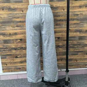 Detail shot of grey wide-leg sweatpants showing elastic high waistband and cotton texture