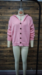 Detailed view of pink hooded knit cardigan with button closure and ribbed cuffs