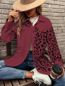 Close-up of burgundy shirt jacket featuring leopard print sleeve and front chest pocket