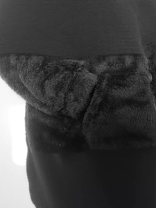 Close-up of black fleece jacket showing the contrast between knit and plush textures