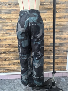 Detail view of high waist camouflage cargo pants with large side utility pockets