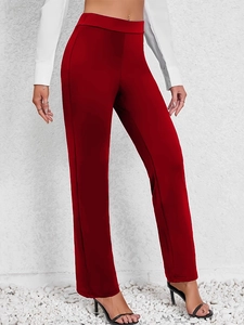 Elegant women's high-waisted red straight trousers paired with black sandals