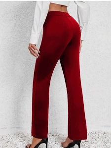 Rear view of high-waisted red flare pants showing slim fit and elegant drape style