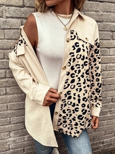 Close-up of corduroy texture with leopard print patchwork and button-down chest pockets
