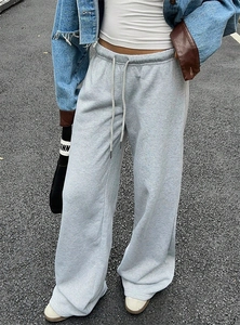 Detail of grey wide-leg sweatpants with elastic drawstring waist in vintage street style