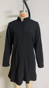 Detail view of stylish black stand-up collar jacket with elegant buttons and slim fit