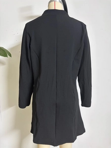 Back view of slim fit black long sleeve jacket with textured fabric and cinched waist