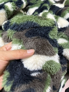 Detailed close-up showing soft camo fleece texture and thick plush fibers on the jacket