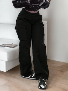 Detailed view of high-waisted black cargo pants with large side flap pockets