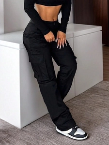 Women's black high-waisted cargo pants with multi-pocket design and street style fit
