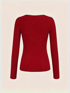 Detail view showing red ribbed cotton fabric texture and slim fit long sleeve design