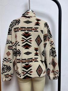 Detail view of ethnic geometric print and fleece texture on retro winter jacket