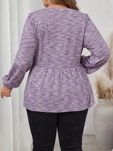Detail of purple peplum top with textured knit fabric and tiered ruffle hem on back