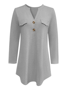 Detail of V-neck button closure and flap pockets on grey long sleeve casual shirt
