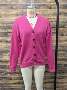 Detail of rose red V-neck knit cardigan showing ribbed cuffs and five dark brown buttons