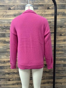 Rear view of pink knitted cardigan featuring ribbed cuffs and a relaxed fit