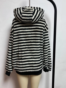 Close-up detail of soft faux fur texture on black and white striped oversized hoodie
