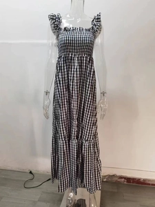 Close-up of black and white gingham dress featuring elastic smocked chest and tiered skirt