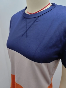 Detail of cross-stitched crew neck on blue, grey and orange colorblock sports t-shirt