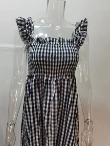 Detail of the smocked bodice and ruffled straps on this black and white gingham dress