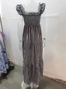 Detail of smocked bodice and ruffled neckline on black and white checkered maxi dress