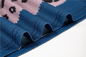Macro view of leopard print ribbed knit fabric with precise double-needle stitching detail
