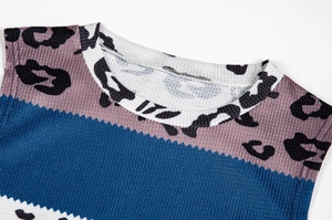 Detail of color-block leopard print top with ribbed knit texture and round neckline