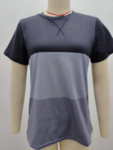 Detail view of the decorative X-stitch neckline on a color-block short-sleeved t-shirt