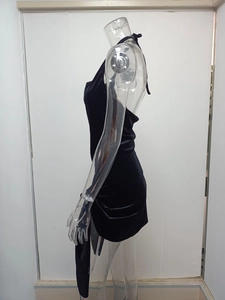 Close-up of elegant black velvet halter dress with backless design and stylish side ribbon