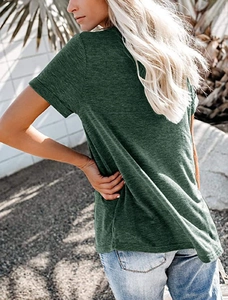 Side view of woman in dark green V-neck short sleeve T-shirt and light blue jeans