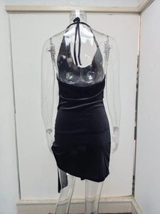 Detailed back view of sexy black halter backless mini dress with asymmetric hem on a mannequin