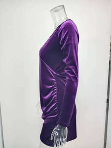 Detail view of purple velvet dress showing V-neck design and ruched side textures