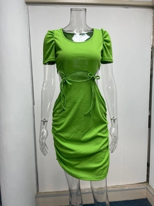 Dettaglio di abito in maglia verde lime con tagli laterali e maniche a sbuffo arricciate