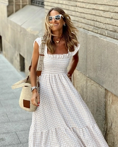 Detail of smocked elastic bodice and brown gingham pattern on summer maxi dress