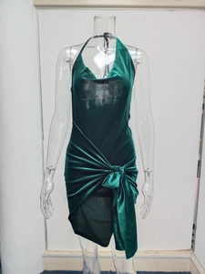 Detail of the halter neckline and velvet texture on this dark green party dress