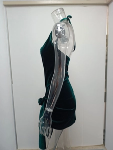 Detail of green velvet halter dress featuring side drawstring ruching and slit design