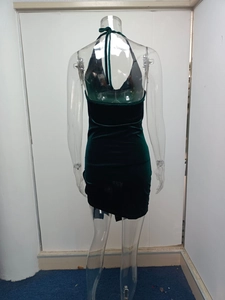 Detail of dark green velvet halter dress featuring slim fit and deep V backless design