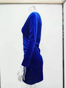 Detail of royal blue velvet dress with slim fit long sleeves and side ruched waist