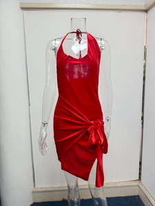 Detailed side view of red velvet halter dress featuring ruched knot and side slit