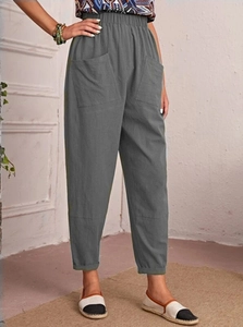 Detail of dark grey cotton linen pants featuring elastic high waist and large side pockets