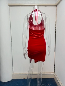 Detail view of red halter backless mini dress with asymmetric hem on a mannequin