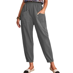 Detail of dark gray cotton linen pants featuring an elastic waist and large front pockets