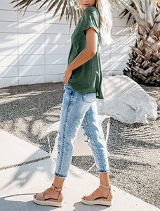 Close-up of a green V-neck T-shirt paired with light blue distressed jeans for summer