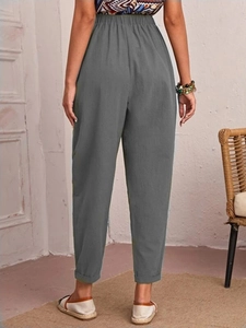 Back view of women's gray cotton linen pants featuring an elastic waist and cuffed hems