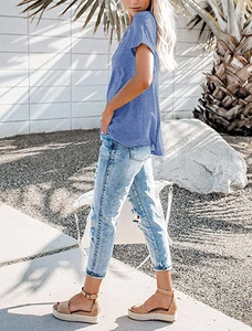 Women's V-neck blue t-shirt and ripped denim jeans for a casual summer outdoor look