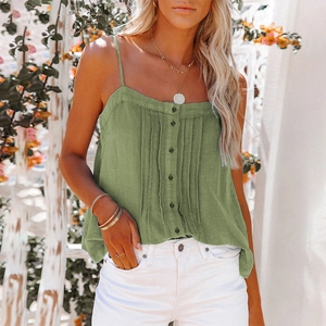 Detailed close-up of grass green camisole with decorative buttons and vertical pleats