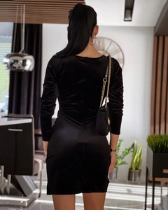 Detail of black long-sleeved bodycon dress featuring velvet and satin patchwork design