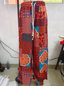 Detail of high waisted wide leg floral trousers with bohemian print and drawstring waist